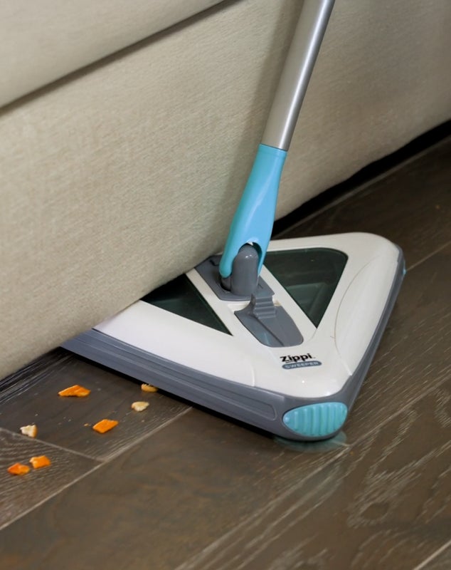 Zippi Sweeper reaching under furniture
